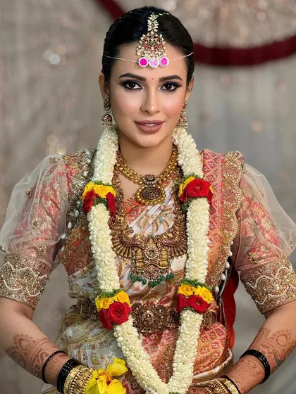 Another beautiful portrait with the flower garland, capturing the bride's happy and serene expression.