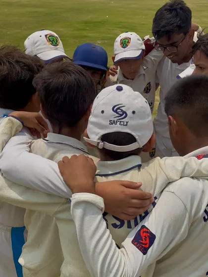 A team huddle during a tense chase in the final. Strategy and motivation are key.
