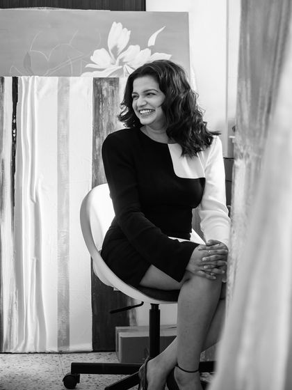 A portrait of me in my studio, surrounded by canvases. Art is a way of telling silent stories, like the strength and resilience whispered by a gladiolus flower.