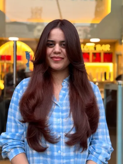 A happy client with her new copper and brown global hair color. The shade brightens her features beautifully.