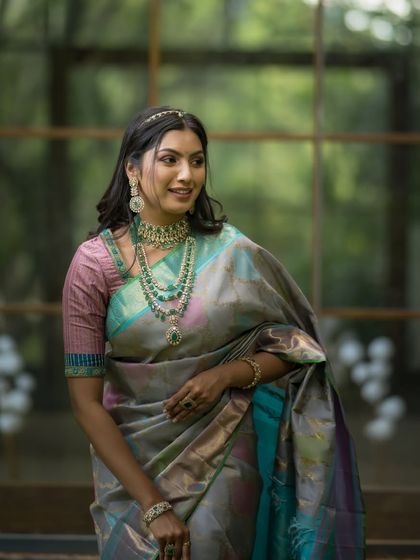 A happy and confident portrait, the model's smile as bright as the beautiful colors in her saree.