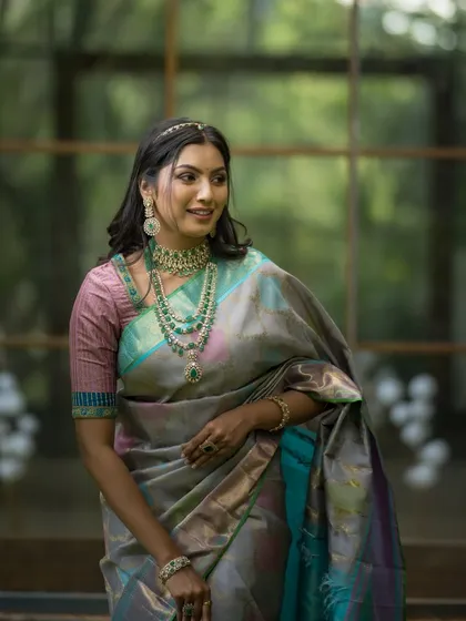 A happy and confident portrait, the model's smile as bright as the beautiful colors in her saree.