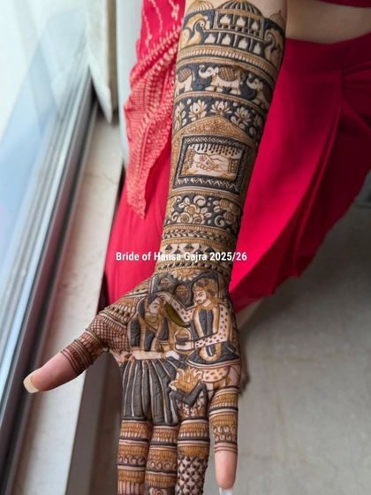 A close-up of a storytelling design featuring a varmala scene on the palm. The arm is decorated with traditional elements like elephants and palace architecture.