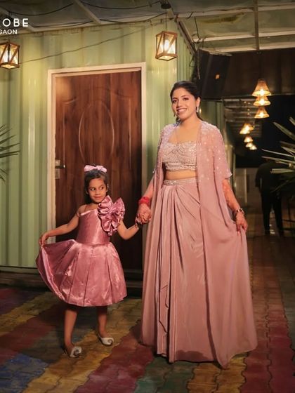 Twinning with her little one. This client and her daughter are adorable in matching pink outfits, perfect for a special family occasion.