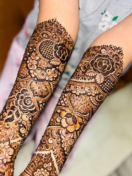 A close-up of the intricate details on the forearms. The mix of floral, geometric, and check patterns is stunning.