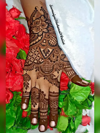 A close-up of the party henna design, showcasing the intricate rose and leaf patterns.