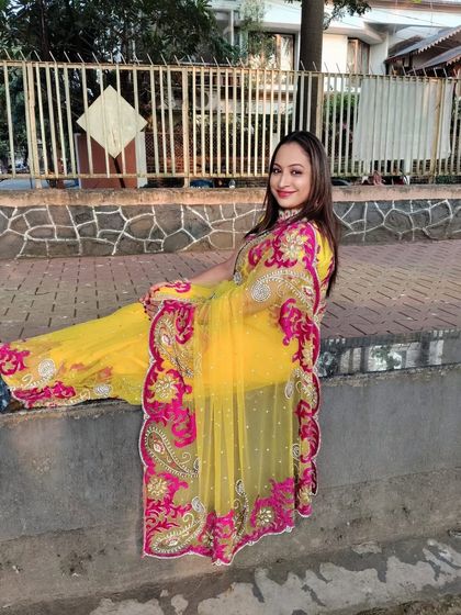 This yellow saree with a pink border is perfect for festivals like Karwa Chauth or for a pre-wedding shoot.