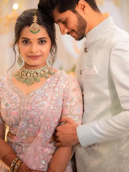 A perfect couple, ready for their engagement. I created a soft, romantic makeup look with a messy updo to complement her delicate pastel lehenga, ensuring she looked effortlessly elegant.
