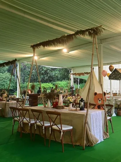 A 'Boho Chic Animal' party inside a waterproof tent, featuring rustic tables and safari-inspired elements.