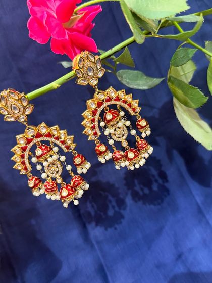 These exquisite red and white chandbali earrings with pearl drops are a work of art. They are perfect for a bride or for anyone attending a grand wedding.