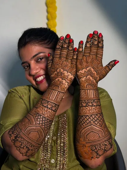 My beautiful friend, all smiles as she shows off her full bridal mehendi. The design is intricate and traditional, perfect for her big day.