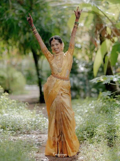 A moment of pure, uninhibited joy. The bride raises her arms in celebration, a perfect expression of her excitement and happiness.