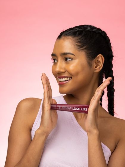 Framing the product with her hands, the model creates a focal point that is both creative and effective. Her bright smile and engaging expression make the entire shot feel warm and inviting.