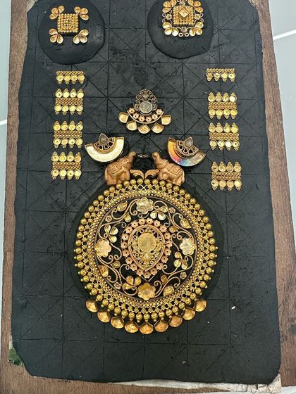 This is our layout board, where the magic begins. Here you can see how we arranged the various pieces from three earrings, two chains, and a pendant to design the final, stunning necklace.