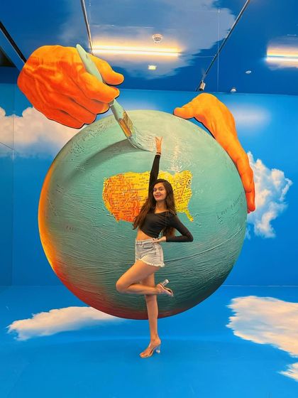 Reaching for the paintbrush. This exhibit was so interactive and visually stunning.