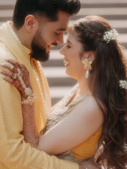 Pure, uninhibited joy. This close-up from a Haldi ceremony captures the couple's radiant smiles and laughter, a moment of genuine happiness that is both beautiful and infectious.