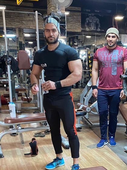 In the gym with a training partner. Surrounding yourself with strong people helps you stay motivated and push harder.