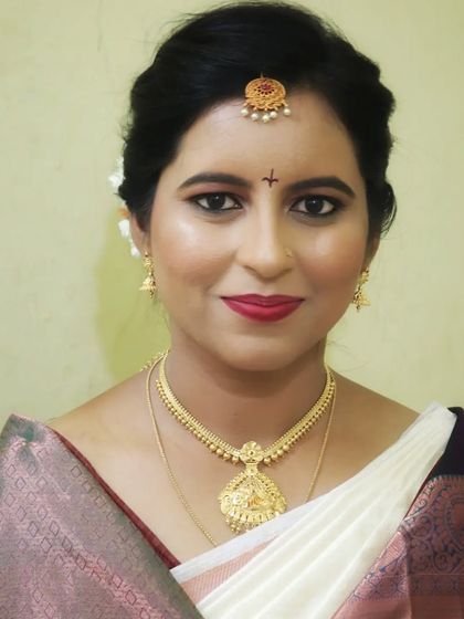 A classic bridal portrait. The makeup is kept clean and elegant, allowing the bride's natural beauty and her traditional attire to shine.