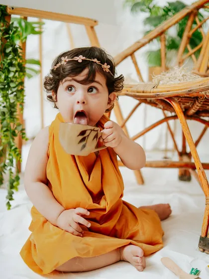 "Is it tea time already?" This baby girl's expressive face is the highlight of her creative, boho-themed milestone shoot.