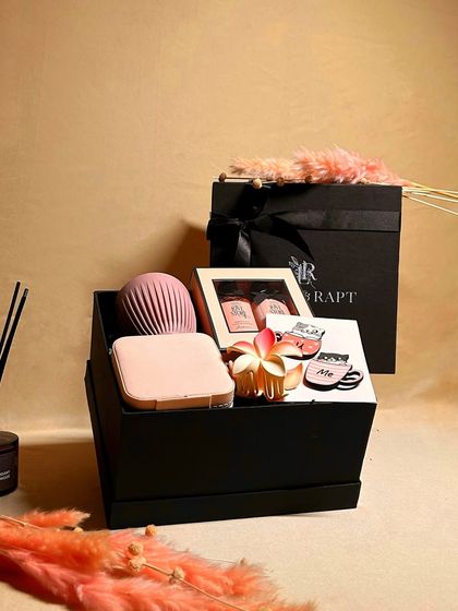 An inside look at the 'Blissful Treasures' hamper, showing how each item is carefully placed within the signature black 'Lush & Rapt' gift box.