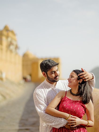 A romantic portrait with the stunning backdrop of Amer Fort, capturing the couple's love in a historic and majestic setting.