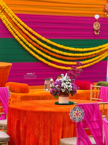 A view of the guest tables set against the colorful backdrop, showing the cohesive and festive atmosphere.