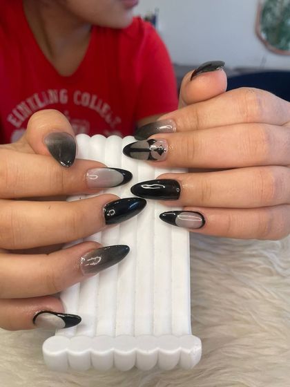 Another angle of the moody black manicure, highlighting the ombré and French tip details.