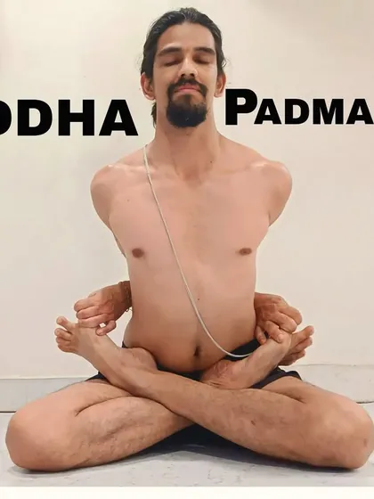 Baddha Padmasana (Bound Lotus Pose) is an advanced variation of lotus that opens the heart and increases vitality. The binding action of the arms creates a deep shoulder and chest stretch.