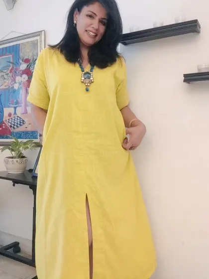 This bright yellow linen dress is perfect for a fun day out with friends. It's comfortable, cheerful, and easy to style.