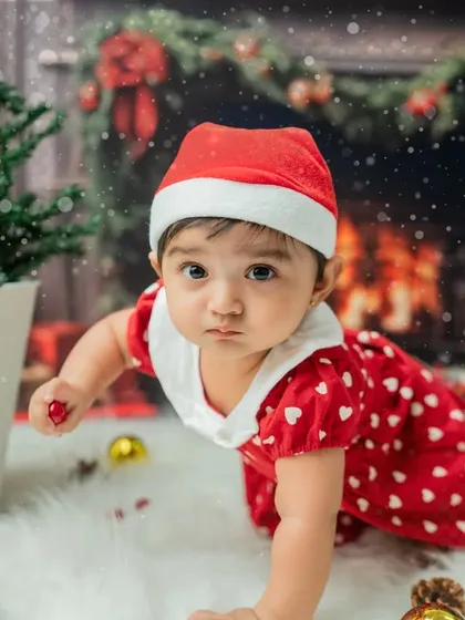 The crawling milestone captured during a Christmas mini-session. The determined look on her face as she reaches for an ornament is a precious memory.