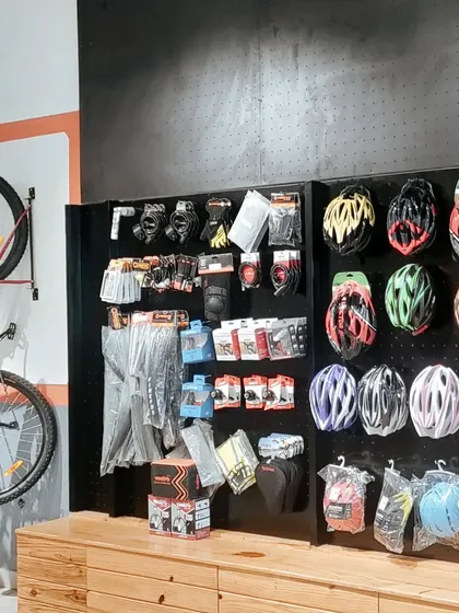 A well-organized accessory wall is crucial in a retail environment. I used a black pegboard system to create a flexible and visually clean display for helmets, gloves, and other cycling gear.