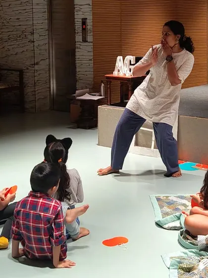 A snapshot from one of our lively storytelling sessions. An expressive storyteller captivates a group of children, bringing a story to life with actions and expressions.