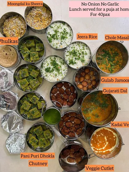A complete no onion, no garlic lunch I served for a puja at home for 40 guests. The menu had Moongdal ka Sheera, Jeera Rice, Chole Masala, Gulab Jamoon, Gujarati Dal, Kadai Veg, Veg Cutlets, and Pani Puri Dhokla.