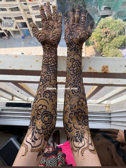 A stunning shot of a full bridal mehendi held up against a window, highlighting the incredible detail.