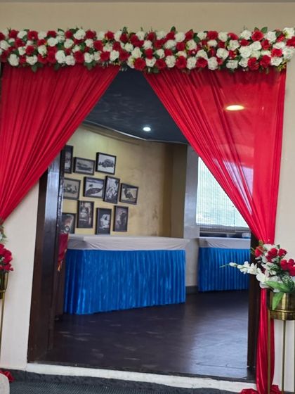 A closer view of the elegant red and white entrance decor for a baby shower.
