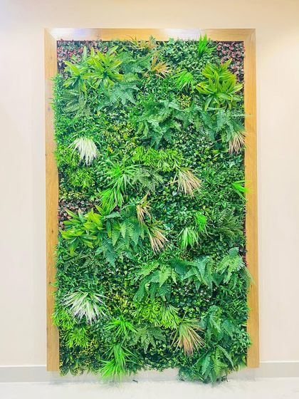 This framed vertical garden panel is ready for display. The dense, multi-layered foliage creates a rich texture that looks like a carefully maintained living wall, but requires no effort.