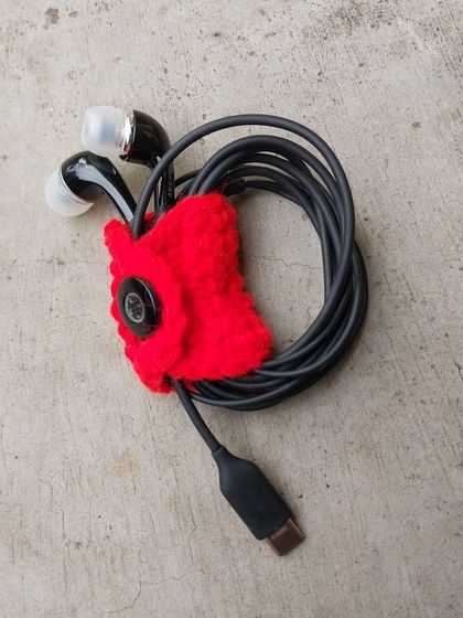 Tired of tangled earphones? This little crochet bell-shaped holder snaps shut to keep your cables neat and tidy.