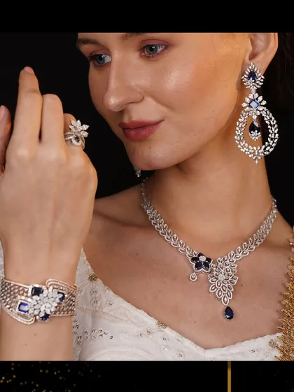 A symphony in sapphire and diamonds. This complete ceremonial set, featuring a necklace, bracelet, earrings, and ring, is designed for grand occasions. The deep blue of the sapphires provides a stunning contrast to the sparkle of the diamonds.