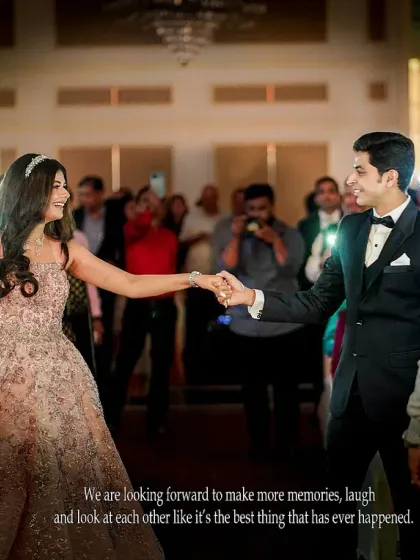 The grand entrance as husband and wife. This candid shot captures the couple's happiness as they are greeted by their loved ones.