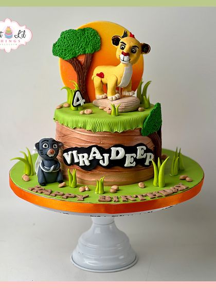 A roaring Lion King cake for a 4th birthday. This design features Simba and Bagheera in a vibrant jungle setting, perfect for a fan of the classic story.