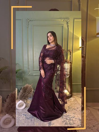 A confident pose in the wine-colored gown, showcasing its elegant silhouette.