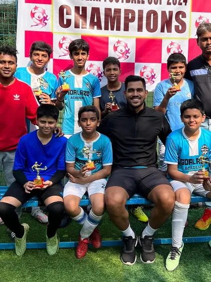 The U-13 team with their coaches and trophies after participating in the New Year Cup.