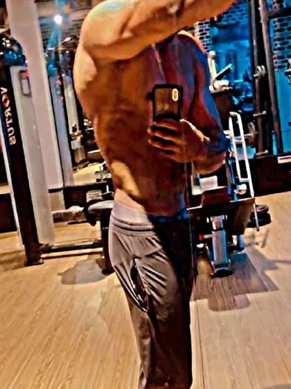 A side pose showing the striations in the chest and shoulder muscles. This level of detail is a hallmark of being stage-ready.
