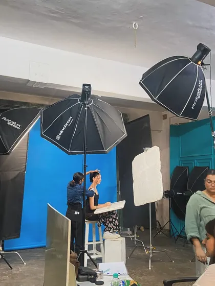 A glimpse into a hands-on learning session. Here, we are building a classic portrait lighting setup with an umbrella and softbox, demonstrating how different light shapers create specific moods for beauty and fashion photography.