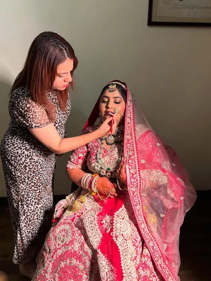 Another angle of me perfecting the bride's lip color. Precision is key to achieving a flawless and long-lasting bridal look.