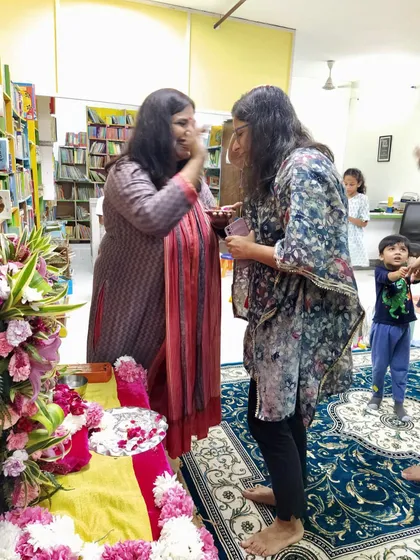 Sharing a moment of joy and blessing during the Ganesh Chaturthi event. These celebrations are as much for the parents as they are for the children, fostering a sense of community.
