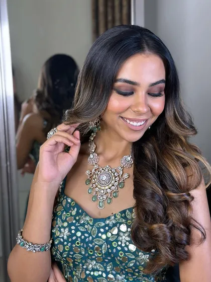 A close-up of the soft brown smokey eye, paired with voluminous waves and stunning polki jewelry.