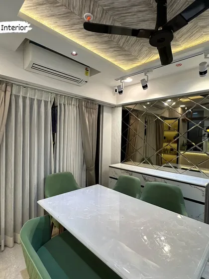 Another angle of the dining room, highlighting the comfortable bench seating and the elegant combination of materials and textures.