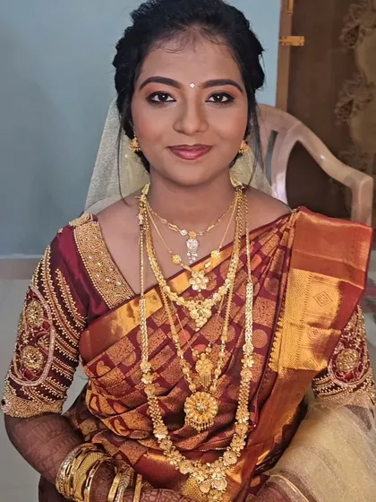 A Christian wedding look with a traditional maroon saree and a white veil, a beautiful fusion of styles.