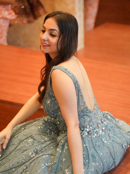 A smiling shot in the grey gown, showing how I bring a joyful and positive energy to my shoots.